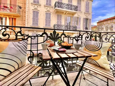 a table on a balcony with a bowl of fruit at LIBERATION CENTER - PRIVATE Balcony - 24&7 RECEPTION - LUGGAGE STORAGE in Nice
