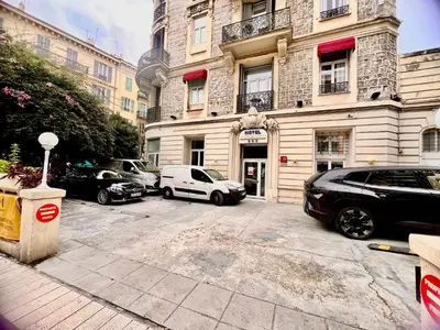 a parking lot with cars parked in front of a building at LIBERATION CENTER - PRIVATE Balcony - 24&7 RECEPTION - LUGGAGE STORAGE in Nice
