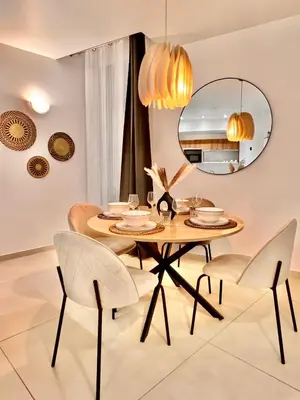 a dining room with a table and chairs and a mirror at LIBERATION CENTER - PRIVATE Balcony - 24&7 RECEPTION - LUGGAGE STORAGE in Nice