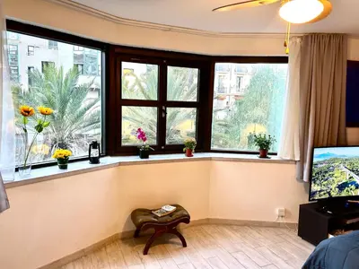 a living room with windows and a chair in front at SuperbeStudio in Nice - 450m of the sea- garden view in Nice