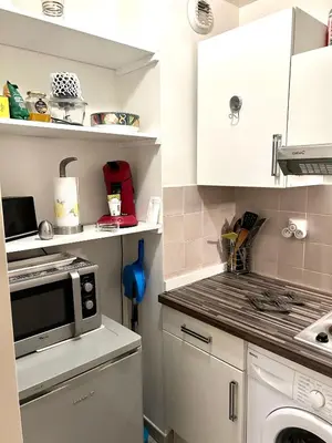 a kitchen with a stove and a microwave at SuperbeStudio in Nice - 450m of the sea- garden view in Nice