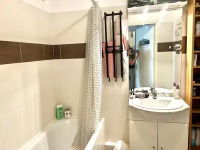 a person taking a picture of a bathroom with a tub and sink at SuperbeStudio in Nice - 450m of the sea- garden view in Nice