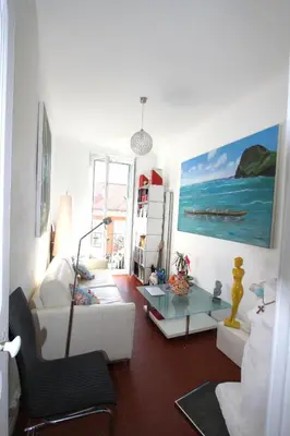 a living room with a white couch and a table at APPARTEMENT NICE le PORT in Nice