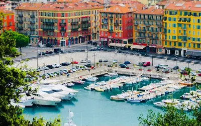a marina with boats in the water next to buildings at APPARTEMENT NICE le PORT in Nice