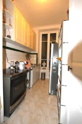 a kitchen with a stove and a refrigerator at APPARTEMENT NICE le PORT in Nice