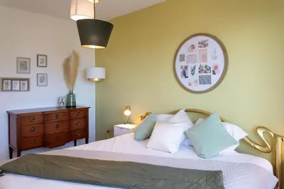a bedroom with a bed with white sheets and a dresser at L11 Claire Fontaine Sea view 2 BDR AC Parking swiming pool in Nice