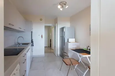 a white kitchen with a sink and a refrigerator at L11 Claire Fontaine Sea view 2 BDR AC Parking swiming pool in Nice