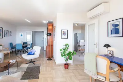 a living room with a table and a dining room at L11 Claire Fontaine Sea view 2 BDR AC Parking swiming pool in Nice