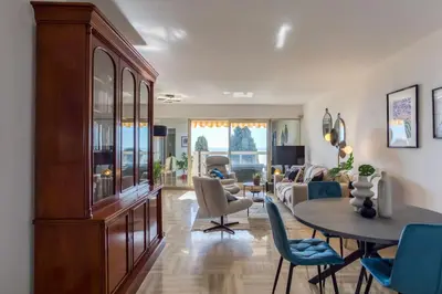 a living room with a table and chairs and a couch at L11 Claire Fontaine Sea view 2 BDR AC Parking swiming pool in Nice