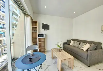 a living room with a couch and a table at Nestor&Jeeves - PALMA BEACH - Proche Mer in Nice