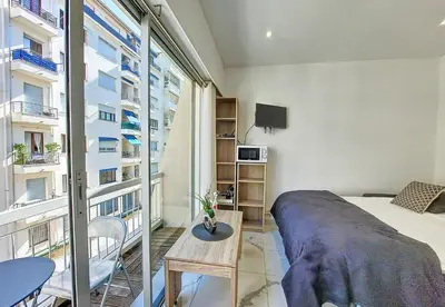 a bedroom with a bed and a large window at Nestor&Jeeves - PALMA BEACH - Proche Mer in Nice