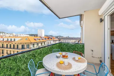 a table and chairs on a balcony with a view at Appartement Loulib I Electio in Nice