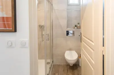 a bathroom with a toilet and a glass shower at L46 2P Port, 2min du Cap et 5 du port/ CLIM & WIFI in Nice