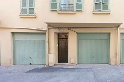 a building with three garages with a door at L46 2P Port, 2min du Cap et 5 du port/ CLIM & WIFI in Nice