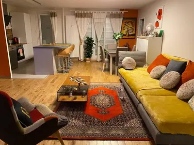 a living room with a yellow couch and a table at Angele Stephen in Nice
