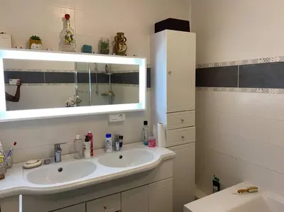 a bathroom with a sink and a mirror at Angele Stephen in Nice