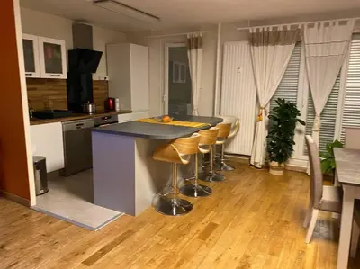 a kitchen with a island with bar stools at Angele Stephen in Nice