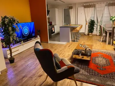 a living room with two chairs and a television at Angele Stephen in Nice