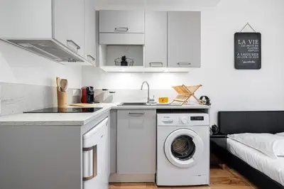 a kitchen with a washing machine and a sink at Charming City Center Studio 108 in Nice