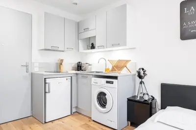 a white laundry room with a washer and dryer at Charming City Center Studio 108 in Nice