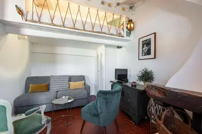 a living room with a couch and a table and chairs at Charming Apartment Old Town in Nice