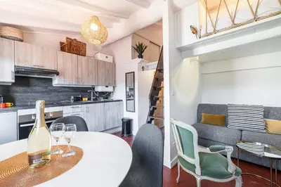 a kitchen and living room with a table and chairs at Charming Apartment Old Town in Nice