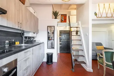 a kitchen with a spiral staircase in a room at Charming Apartment Old Town in Nice