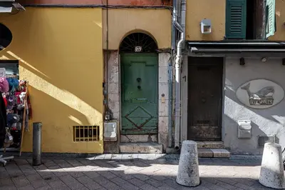 a yellow building with a green door on a street at Charming Apartment Old Town in Nice