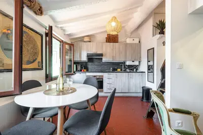 a kitchen and dining room with a table and chairs at Charming Apartment Old Town in Nice