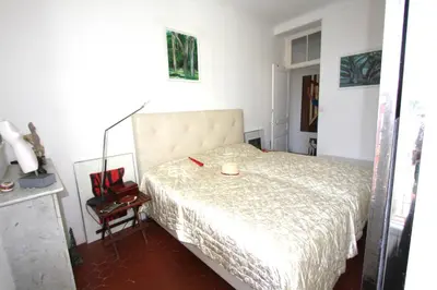 a bedroom with a bed with a candle on it at APPARTEMENT NICE le PORT in Nice