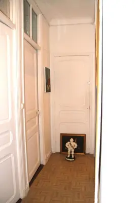 a room with a white door and a toy skeleton in the corner at APPARTEMENT NICE le PORT in Nice