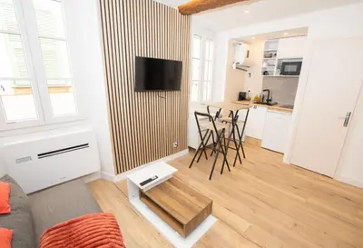 a living room with a couch and a table at Cozy studio in Villefranche-sur-Mer in Villefranche-sur-Mer