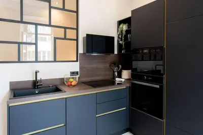 a kitchen with blue cabinets and a sink at L37 F1 Central 2 min de la mer Balcon & CLIM in Nice