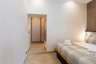 a bedroom with a bed and a hallway at L37 F1 Central 2 min de la mer Balcon & CLIM in Nice