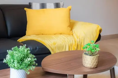 a living room with a yellow couch and a coffee table at L37 F1 Central 2 min de la mer Balcon & CLIM in Nice