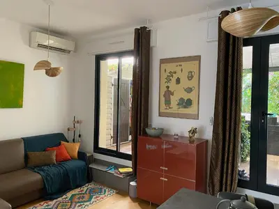 a living room with a couch and a window at Exceptional Terrace in Center of Nice in Nice