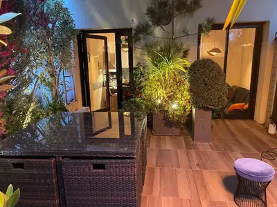 a room filled with lots of potted plants on a wooden floor at Exceptional Terrace in Center of Nice in Nice