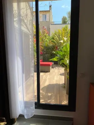 a window with a view of a patio at Exceptional Terrace in Center of Nice in Nice