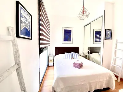 a bedroom with a bed and an american flag at Exceptional Terrace in Center of Nice in Nice