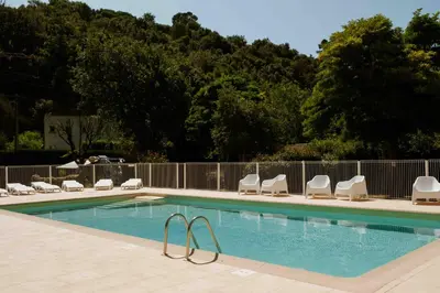 a swimming pool with lounge chairs at Camping VAL FLEURI ATC Cagnes-Sur-Mer in Cagnes-sur-Mer
