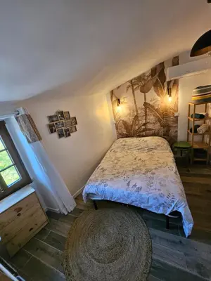 a bedroom with a bed and a large rug at Duplex dans maison de village in Cagnes-sur-Mer