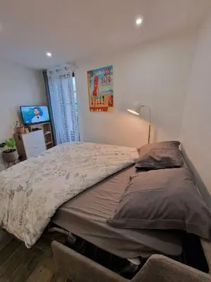 a bedroom with a large bed in a room at Duplex dans maison de village in Cagnes-sur-Mer
