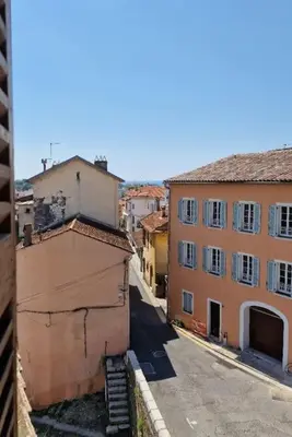 a view of an alley with buildings in a city at Duplex dans maison de village in Cagnes-sur-Mer
