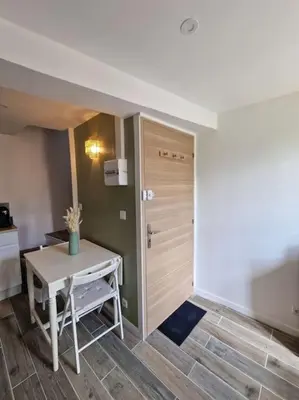 a room with a small table and a door at Duplex dans maison de village in Cagnes-sur-Mer