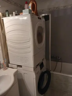 a washing machine in a bathroom next to a sink at Les carlins in Nice