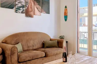 a brown couch in a living room with paintings on the wall at CENTRE VILLE-GRAND APPARTEMENT DE 50 M2 - COSY AVEC TERRASSE -Wifi in Nice