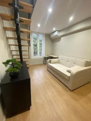a living room with a couch and a table at Duplex sur Nice - Libération in Nice