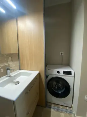 a bathroom with a washing machine and a sink at Duplex sur Nice - Libération in Nice