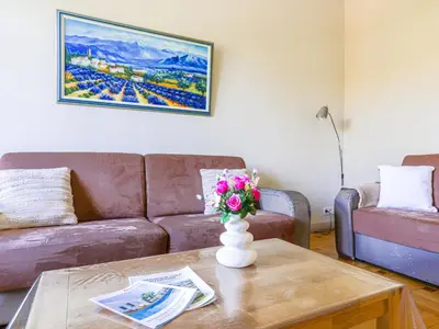 a living room with a couch and a table with flowers at Apartment Le Victor Hugo by Interhome in Nice