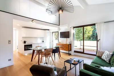 a living room with a green couch and a table at #11 Alex suite terrace parking AC 2 BDR 5mins to sea in Saint-Jean-Cap-Ferrat